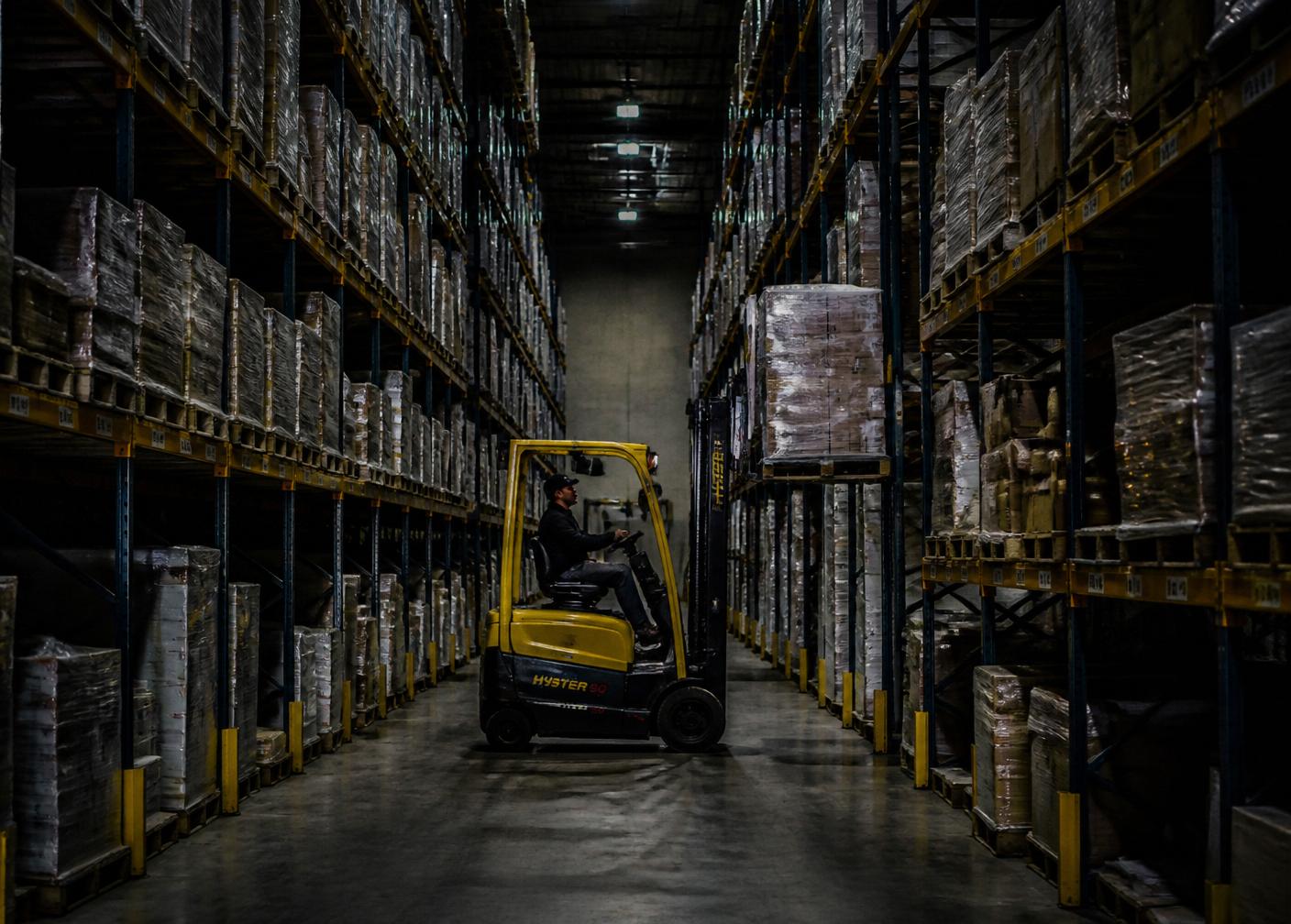 Forklift operating in a warehouse racking aisle